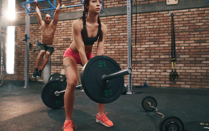 woman-preparing-to-lift-barbell-in-gym-U9ZCU47.jpg